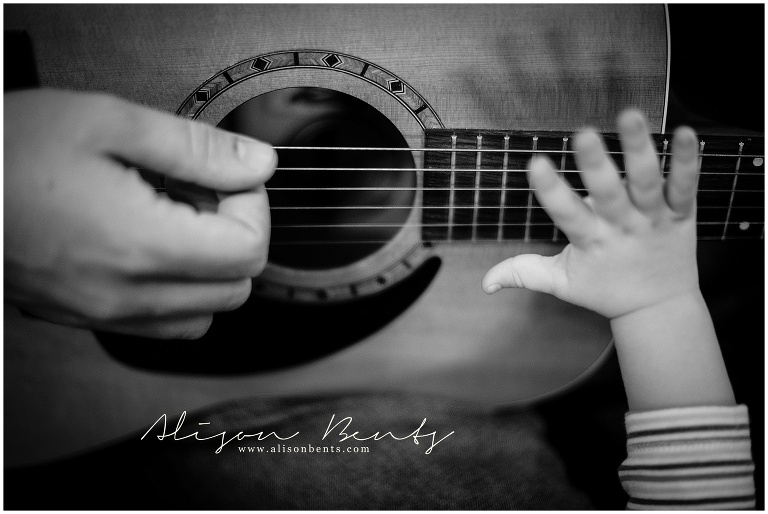 father and son playing guitar together